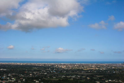 Aerial view of sea and buildings against sky