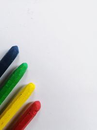 High angle view of colored pencils on white table