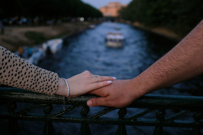 Midsection of couple holding hands