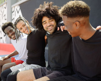 Smiling friends sitting outdoors