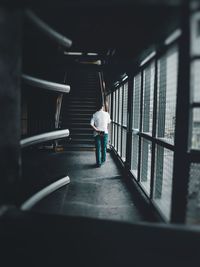 Rear view of man walking in corridor