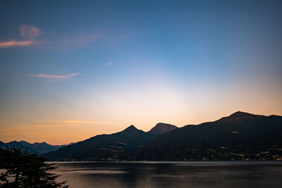 Scenic view of lake against romantic sky at sunset