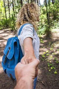 Low section of woman standing in forest