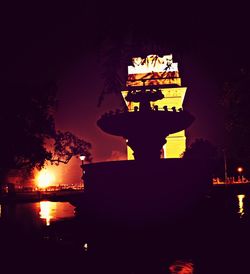 Illuminated building against sky at night