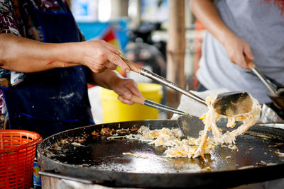 Midsection of man preparing food