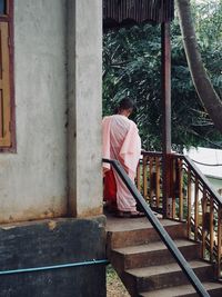 Monk standing on steps at temple