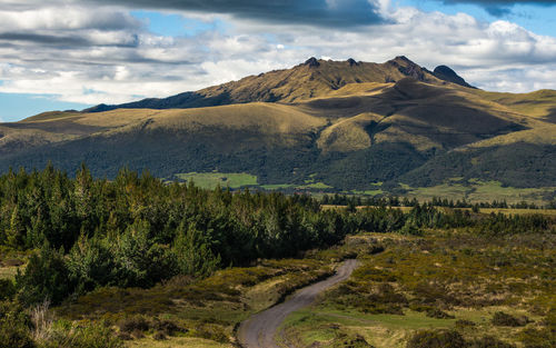 Countryside landscape against mountain range