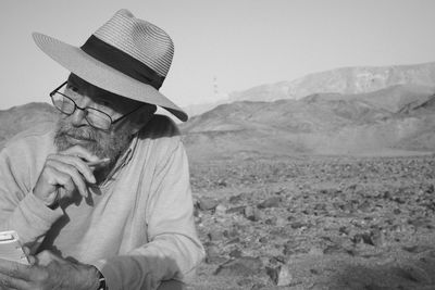 Portrait of man sitting on field