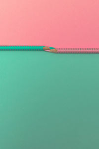 Close-up of pink umbrella over sea