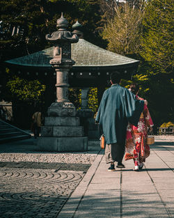 Rear view of women walking at temple