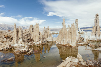 Panoramic view of rocks on shore against sky