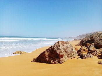 Scenic view of beach against clear sky