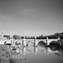 Arch bridge over tiber river against sky