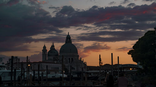 Buildings in city against sky during sunset