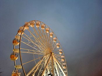 Low angle view of ferris wheel against sky