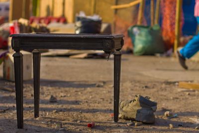 Close-up of empty chairs on table against building