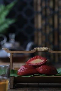 Close-up of red cake or kue ku on table