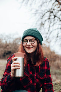 Portrait of young woman using mobile phone