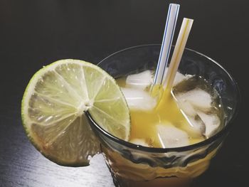 Close-up of drink on table against black background