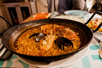 Paella, the traditional dish in spain. cast iron with seafood paella. rice with prawns, mussels