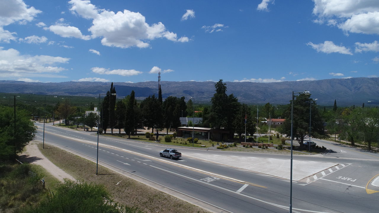 CARS ON ROAD AGAINST SKY