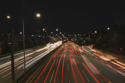 High angle view of light trails on road at night