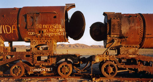 Old train on railroad track against sky