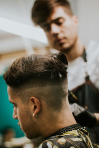 Hairdresser trimming stylish cut