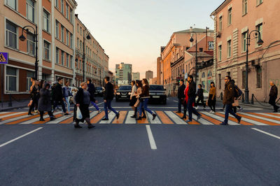 People crossing road in city