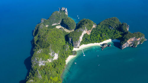 High angle view of rocks in sea against blue sky