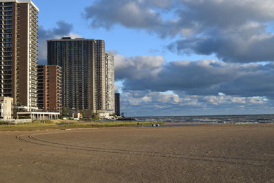 View of beach against cloudy sky