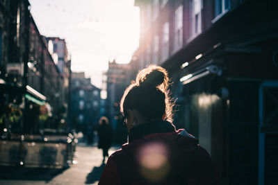 Rear view of people on street in city