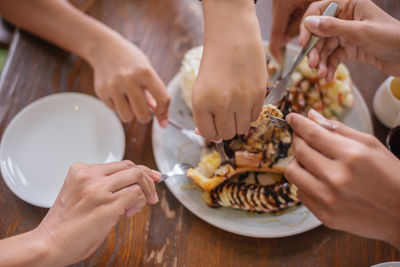 Midsection of woman eating food