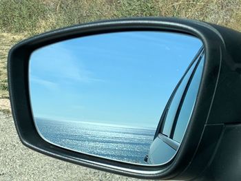 Reflection of sky on side-view mirror