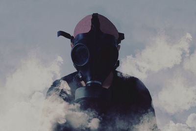 Man in gas mask amidst smoke