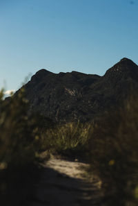 Scenic view of mountains against clear blue sky