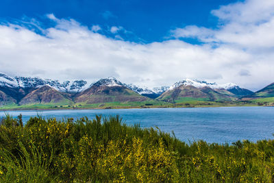 Scenic view of lake and mountains against sky