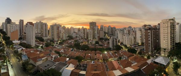 High angle view of city buildings against sky during sunset