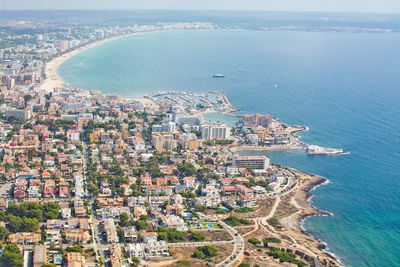 High angle view of townscape by sea