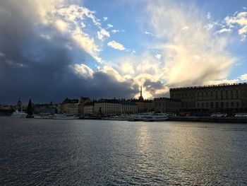 View of cityscape against cloudy sky