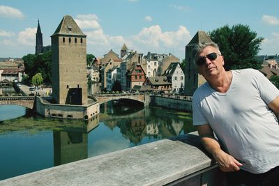 Portrait of mature man wearing sunglasses in city