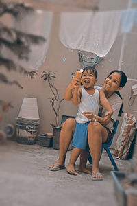 Mother and son playing with bubbles at yard