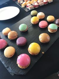 High angle view of multi colored macaroons on table