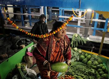 High angle view of woman selling vegetables at market