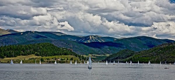 Scenic view of sea and mountains against sky