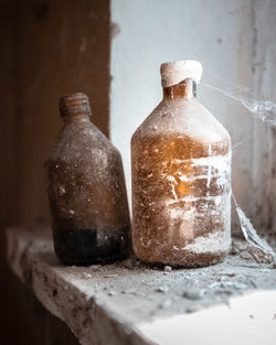 Close-up of old bottles sat on a window 