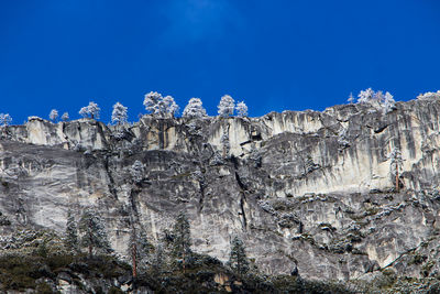 Low angle view of rocks against blue sky in yosemite national park