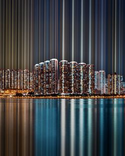 Illuminated modern building in city against sky at night