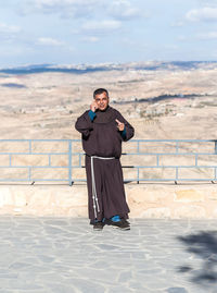 Full length of man standing on landscape against sky