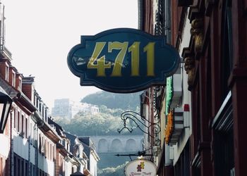 Low angle view of road sign against buildings in city